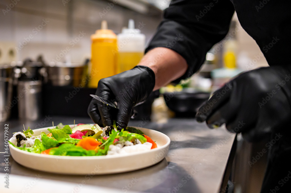 chef hands cooking Fresh sashimi salad with salmon fish, tuna and vegetables on kitchen chef hands cooking Fresh sashimi salad with salmon fish, tuna and vegetables on kitchen