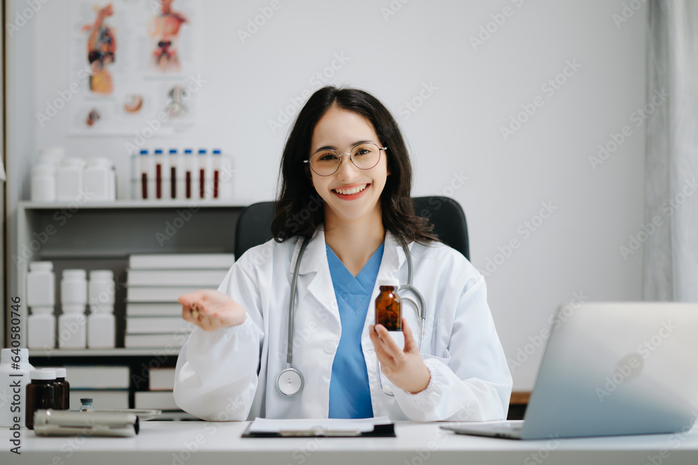 Beautiful physician doctor sit on table in office hospital. Attractive therapist female practitioner pharmacist smile and use tablet and laptop. after success work from treatment Beautiful physician doctor sit on table in office hospital. Attractive therapist female practitioner pharmacist smile and use tablet and laptop. after success work from treatment