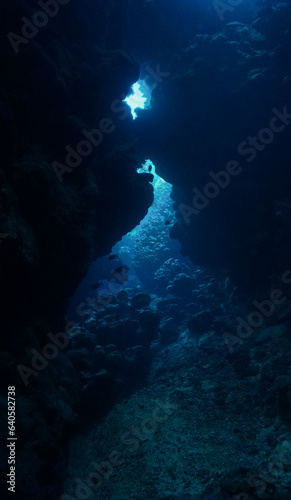 Underwater photo of rays of sunligt inside a cave