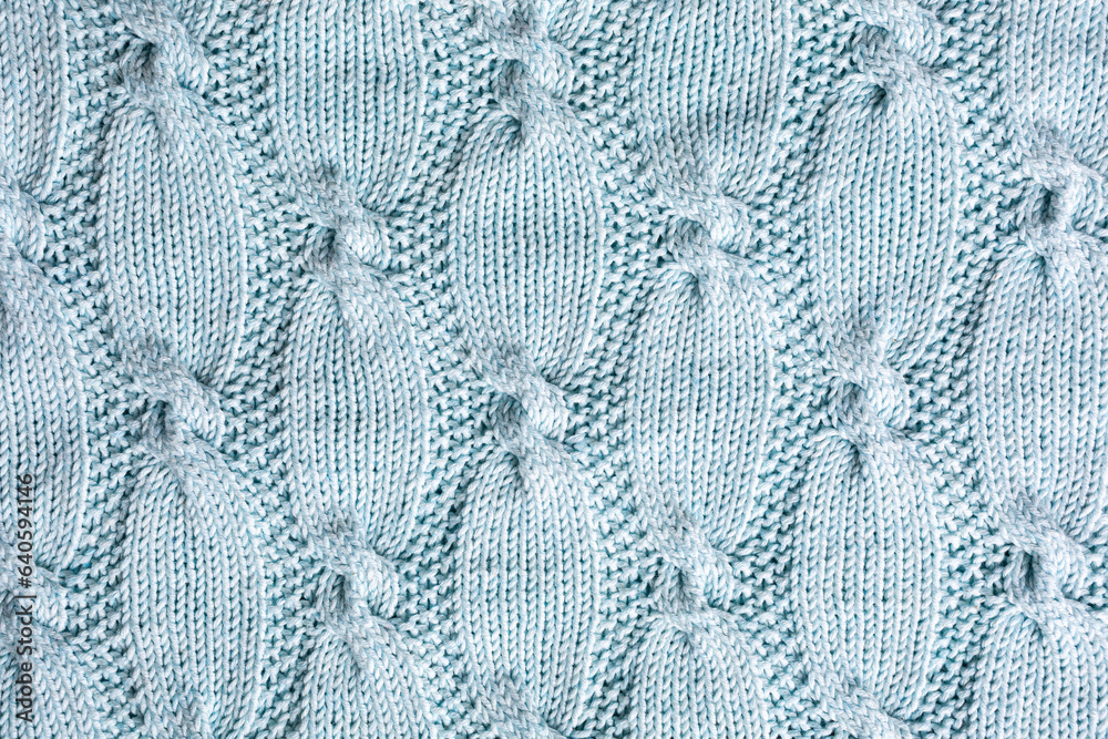 Background with turquoise knitting pattern for sweater with cables. Above overhead shot