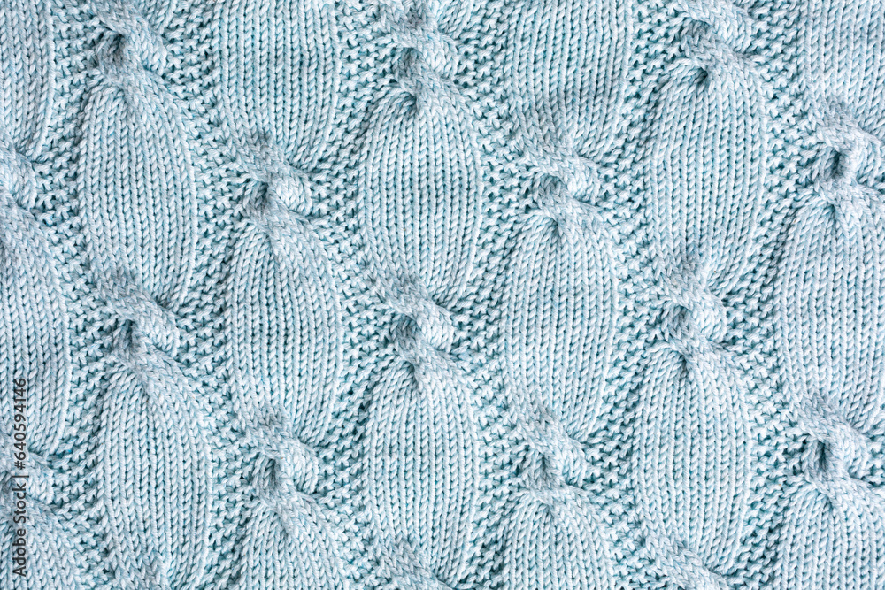Background with turquoise knitting pattern for sweater with cables. Above overhead shot Background with turquoise knitting pattern for sweater with cables. Above overhead shot