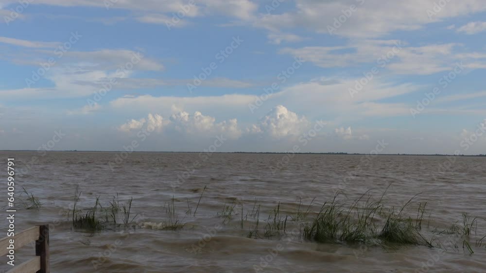 The tidal water in the Padma River is increasing and with it the rough waves are crashing on the banks. The tidal water in the Padma River is increasing and with it the rough waves are crashing on the banks.