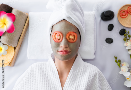 Happy Asian young women clean face skincare treatment and therapy with facial masks from beautician in natural spa.