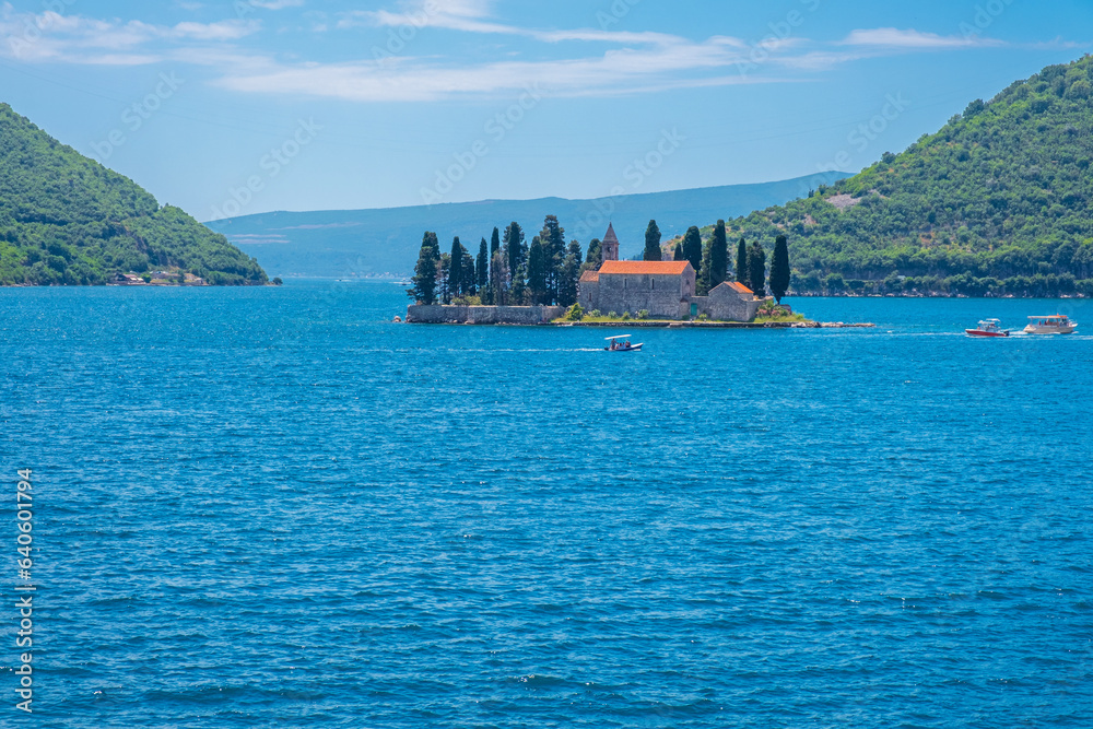 Island Saint George with medieval monastery in the Bay of Kotor near Perast town on Adriatic sea in Montenegro in sunny day. Popular summer vacation destination Island Saint George with medieval monastery in the Bay of Kotor near Perast town on Adriatic sea in Montenegro in sunny day. Popular summer vacation destination