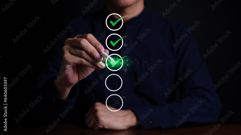 Businessman checking mark on checklist with a red checkmark. online ...