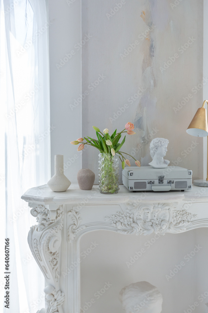 the white fireplace is decorated with stucco in a luxurious istoic palace style in a gentle cozy bright apartment with huge panoramic windows with sunlight the white fireplace is decorated with stucco in a luxurious istoic palace style in a gentle cozy bright apartment with huge panoramic windows with sunlight