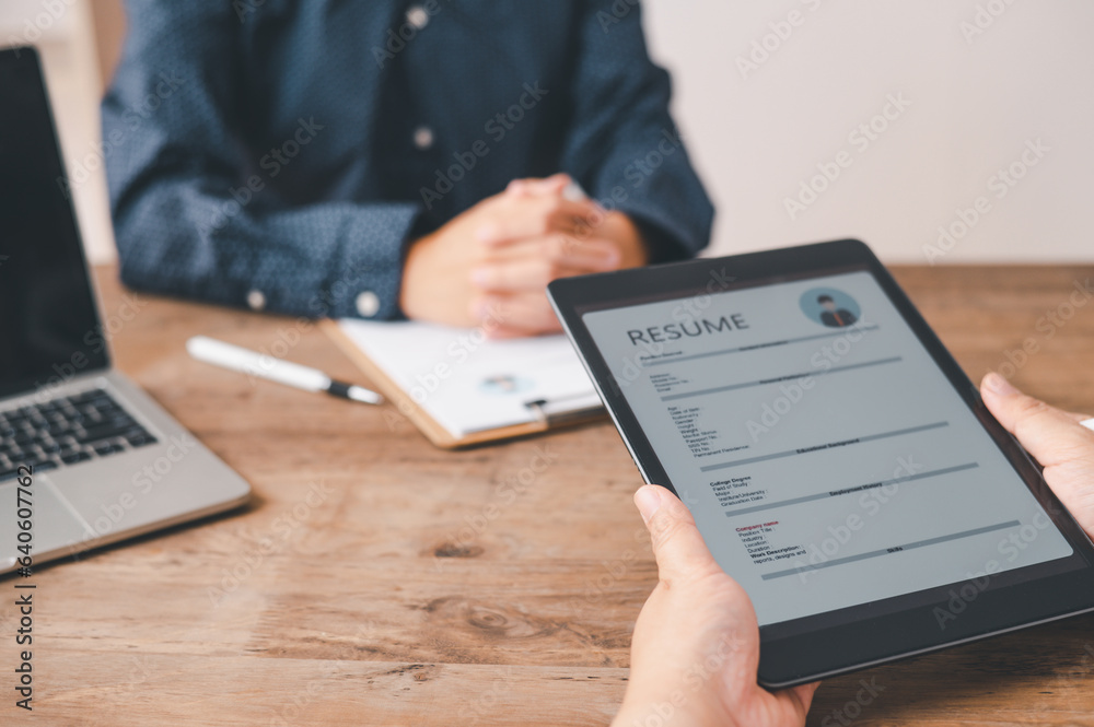 HR managers are interviewing job applicants who fill out their resume on the job application form in order to consider accepting a job as a company HR managers are interviewing job applicants who fill out their resume on the job application form in order to consider accepting a job as a company