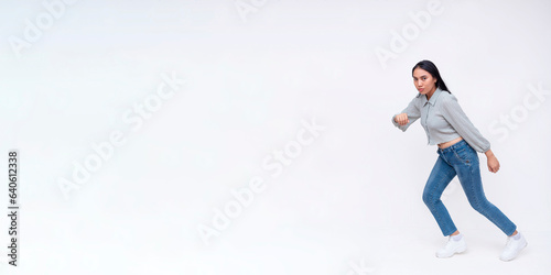Quadro em tela Side view of a dynamic young asian woman running to the left