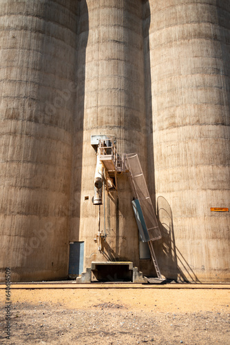 Australian grain silo with a train track in the foreground, unloader ready to fill train cars