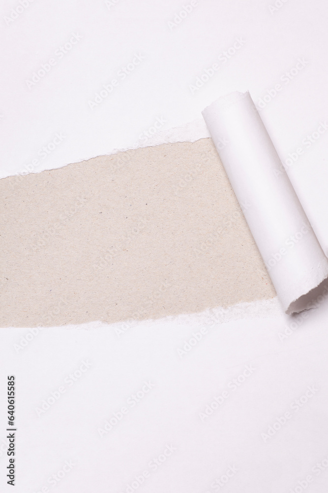 Torn paper with opening showing cardboard paper background Torn paper with opening showing cardboard paper background