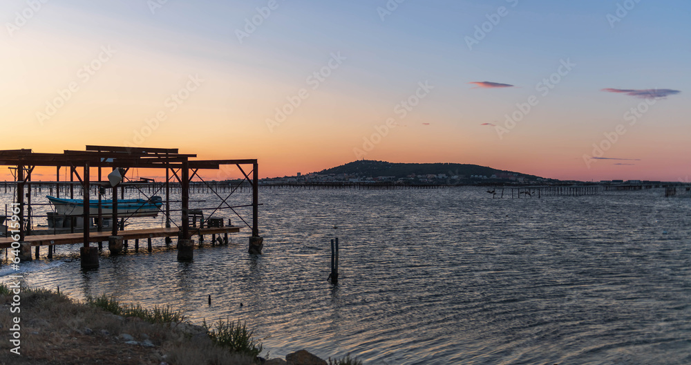 Obraz premium Oyster farm on the Etang de Thau at sunrise, in Loupian, in Occitanie, France