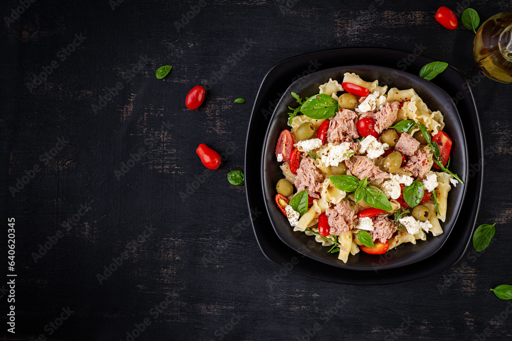 Pasta with tuna, tomatoes and feta cheese. Pasta salad with tuna. Healthy italian food. Healthy dinner. Top view, flat lay Pasta with tuna, tomatoes and feta cheese. Pasta salad with tuna. Healthy italian food. Healthy dinner. Top view, flat lay