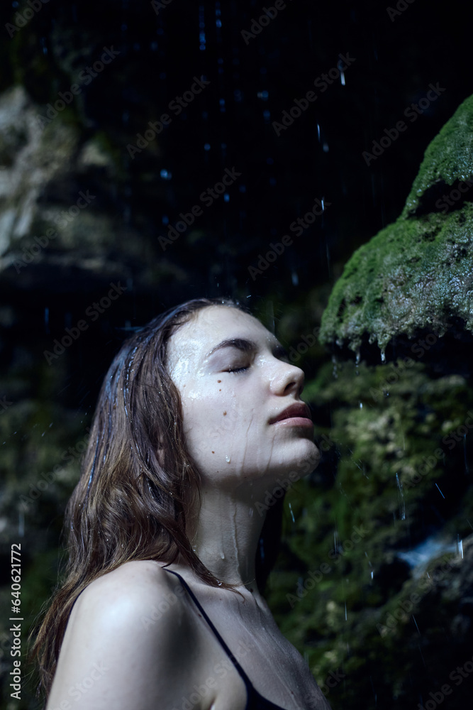 portrait of a beautiful woman under raindrops standing in the forest enjoying nature portrait of a beautiful woman under raindrops standing in the forest enjoying nature