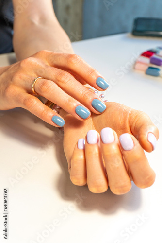 Hands of a young woman with a beautiful manicure on a white background. nail