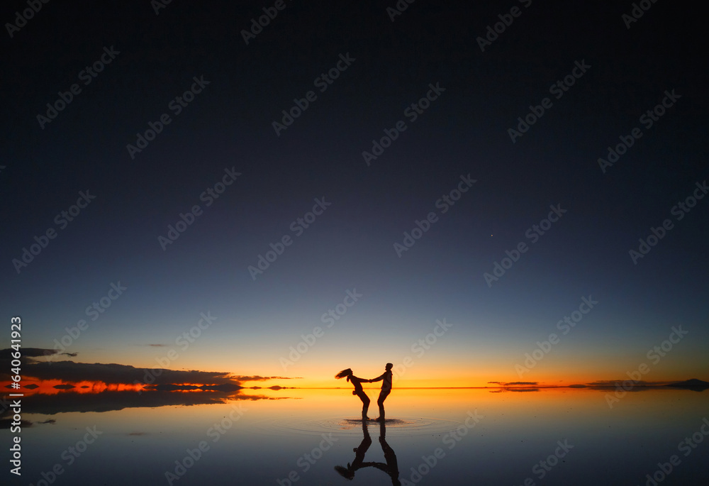 Uyuni salt marsh. Shadows of people at sunset