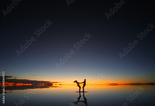 Uyuni salt marsh. Shadows of people at sunset