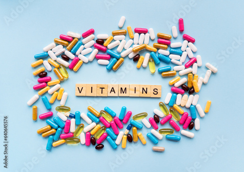 Bright different types of medicines for health. Medicines on a blue background with the inscription vitamins.