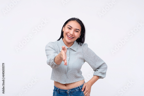 A friendly and chummy young asian woman offers a handshake. A lady giving her congratulations. Isolated on a white background. photo