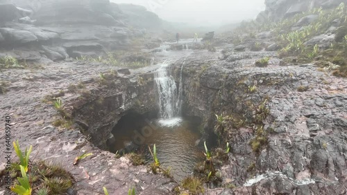 Streams of rainwater flow into big stone opening on top of Tepuy Roraima Mount, 