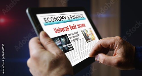 Fotografie Universal basic income analysis technology newspaper on mobile tablet screen