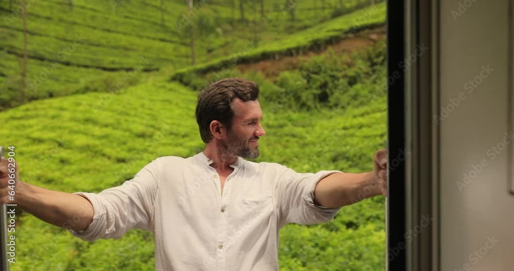 Travel and exploration of tourist Man by train to famous landmarks in Sri Lanka. Touristic journey around tropical country. Tour from Nuwara Eliya to Ella. Extreme attraction, passenger male in white Travel and exploration of tourist Man by train to famous landmarks in Sri Lanka. Touristic journey around tropical country. Tour from Nuwara Eliya to Ella. Extreme attraction, passenger male in white