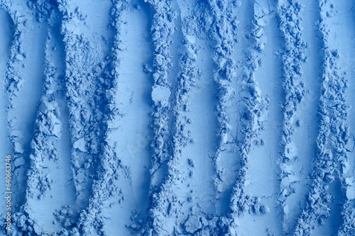 Light blue bentonite facial clay powder (alginate modeling mask, eye shadow, body wrap) texture close up, selective focus. Abstract background with brush strokes.