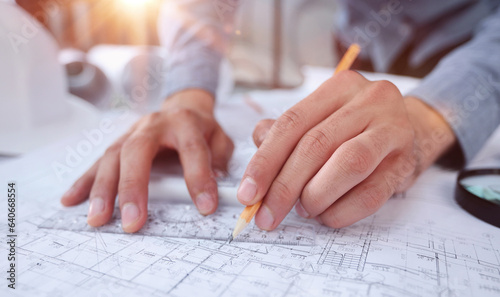 A close-up of male architect working on a project of a residential building