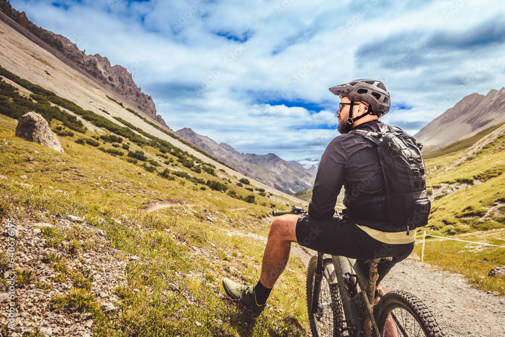 Fototapeta premium Rest on a bike during a trip to the mountains. Biker in a helmet.