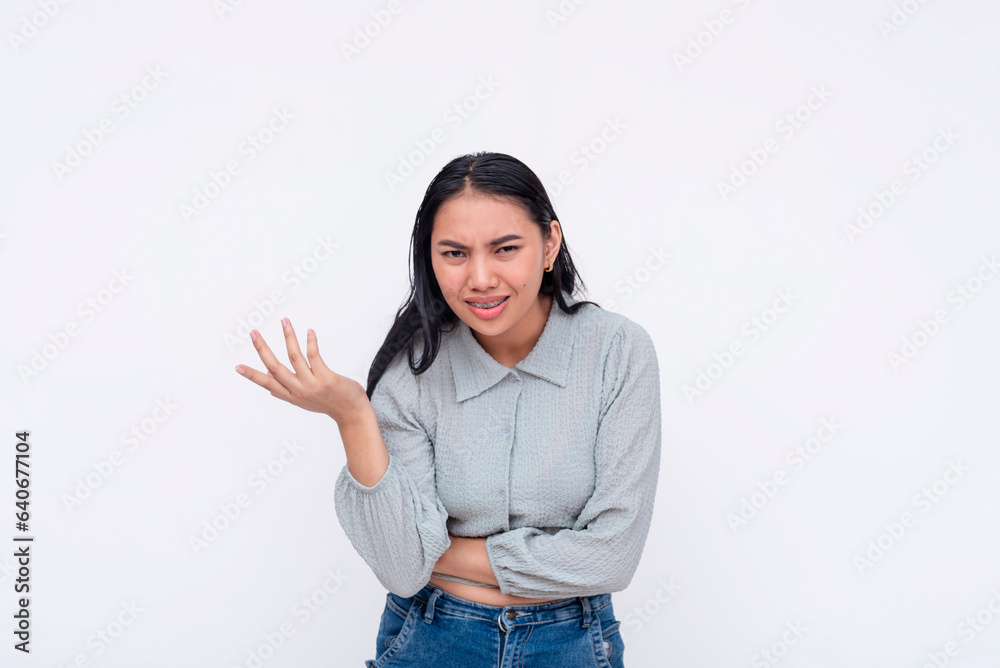 An argumentative and opinionated young woman vehemently opposing a proposal. Looking a bit offended. Isolated on a white background. An argumentative and opinionated young woman vehemently opposing a proposal. Looking a bit offended. Isolated on a white background.