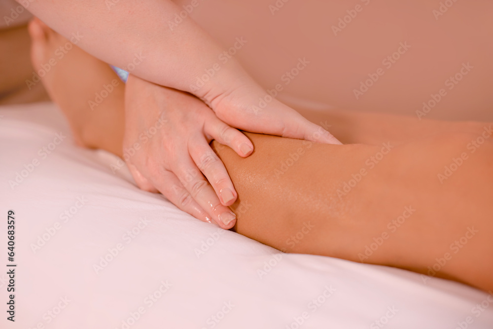 Osteopathy treatment on patient's leg. closeup masseuse hands doing legs massage for woman Osteopathy treatment on patient's leg. closeup masseuse hands doing legs massage for woman