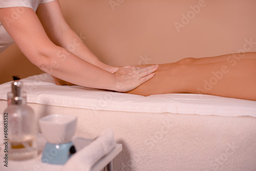 osteopath gently relaxes woman legs in medical center or spa salon