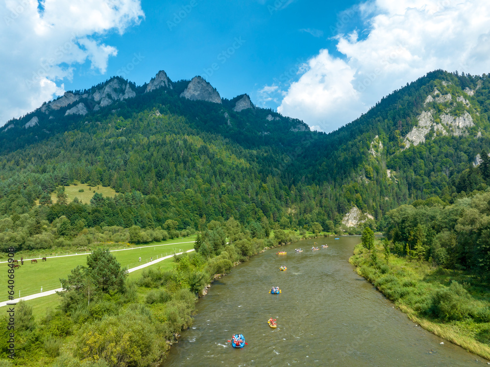 Rafts and canoes approaching Dunajec River Gorge and Trzy Korony Mountain in Poland