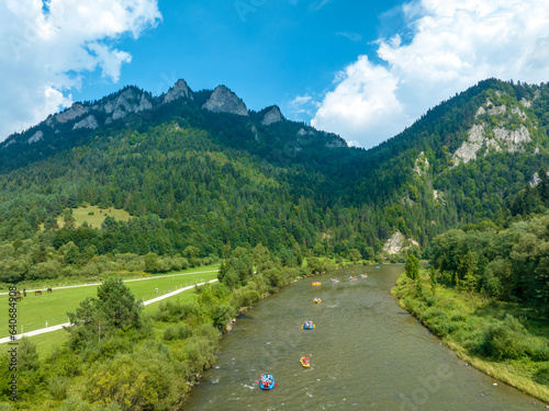 Obraz na płótnie Rafts and canoes approaching Dunajec River Gorge and Trzy Korony Mountain in Poland w salonie