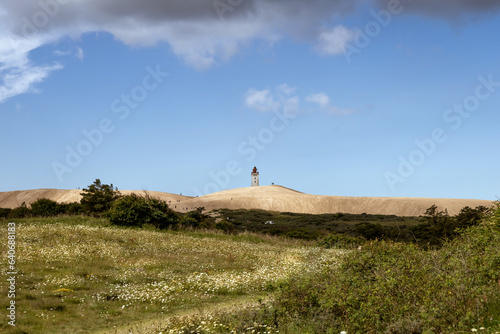 Rubjerg Knude Lighthouse on the coast of the North Sea in the Jutland in northern Denmark. Natural landscape with sand dunes.