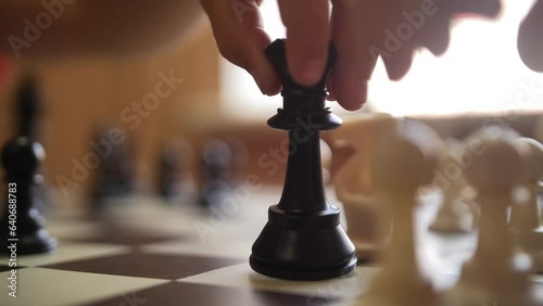 Close-up of a Hand Moving a Chess Piece on the Board. Chess Tournament. Hands, people and chess board game in closeup.