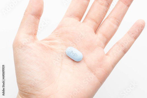 PrEP (Pre-Exposure Prophylaxis) tablet on human hands used to prevent HIV infection. photo