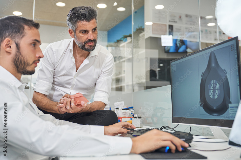Fototapeta premium Concentrated coworkers designing model of respirator