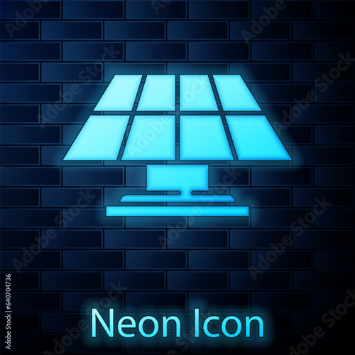 Glowing neon Solar energy panel icon isolated on brick wall background. Vector