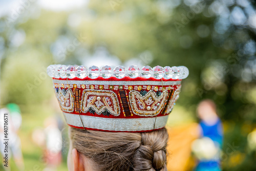 Woman in traditional Latvian costume and national crown close-up photo