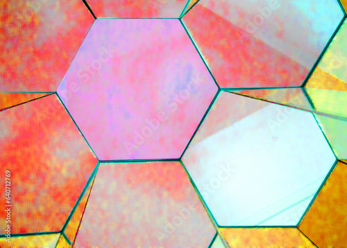 view of a kaleidoscope of mirrors in the form of regular bright multicolored hexagons