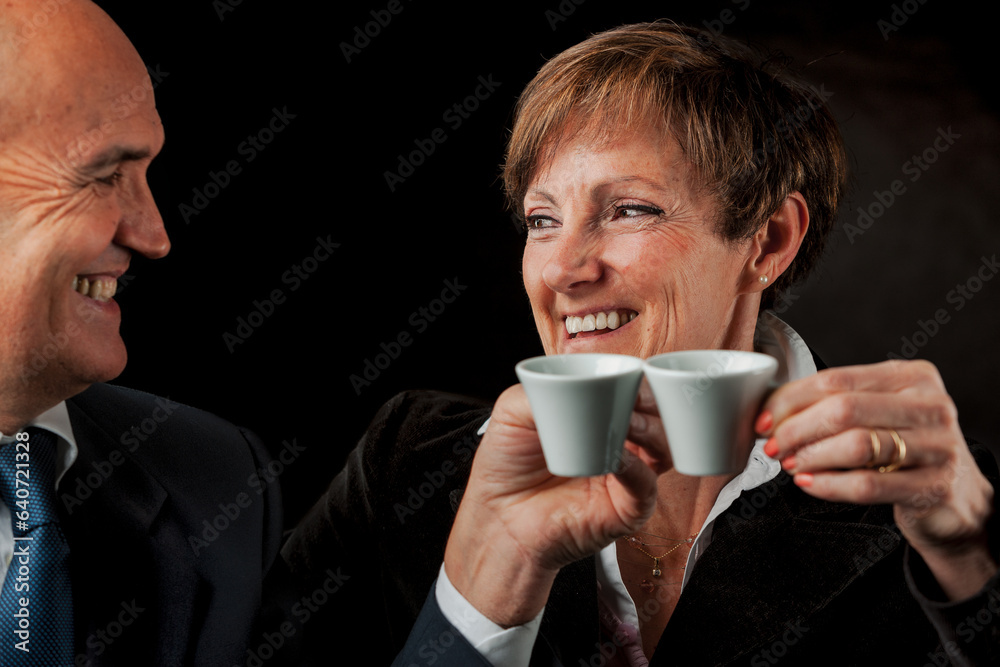 Europe: Elders toast with Italian coffee, smiling Europe: Elders toast with Italian coffee, smiling