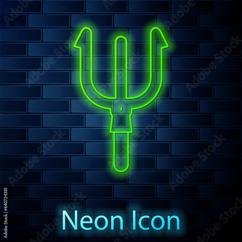 Glowing neon line Neptune Trident icon isolated on brick wall background. Vector