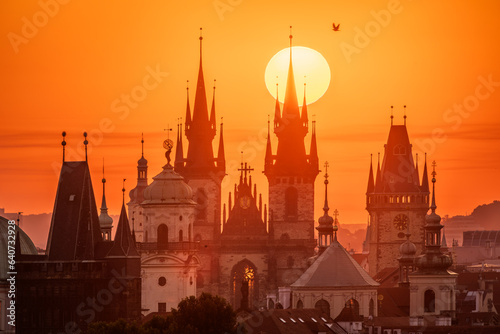 A rising sun behind towers of the Church of Our Lady before Tyn in Prague.
