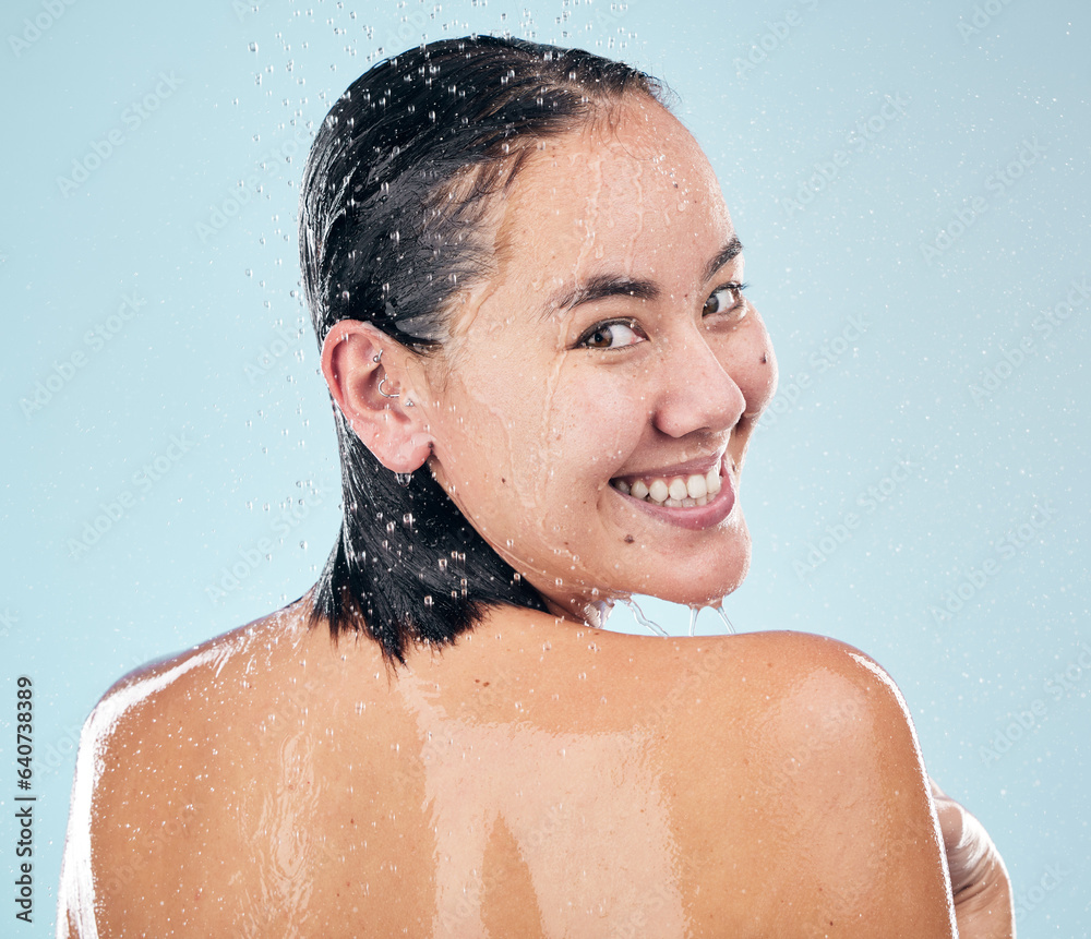 Skincare, shower back and face of woman cleaning in studio isolated on a blue background. Water splash, hygiene and portrait of happy Asian model washing in bath for wellness, health and body beauty Skincare, shower back and face of woman cleaning in studio isolated on a blue background. Water splash, hygiene and portrait of happy Asian model washing in bath for wellness, health and body beauty