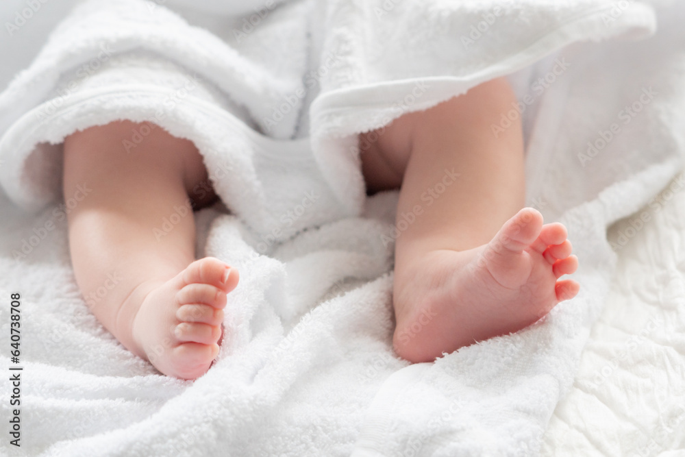 Fresh start showcased by baby's feet under white fabric. Concept of innocence and new journeys Fresh start showcased by baby's feet under white fabric. Concept of innocence and new journeys