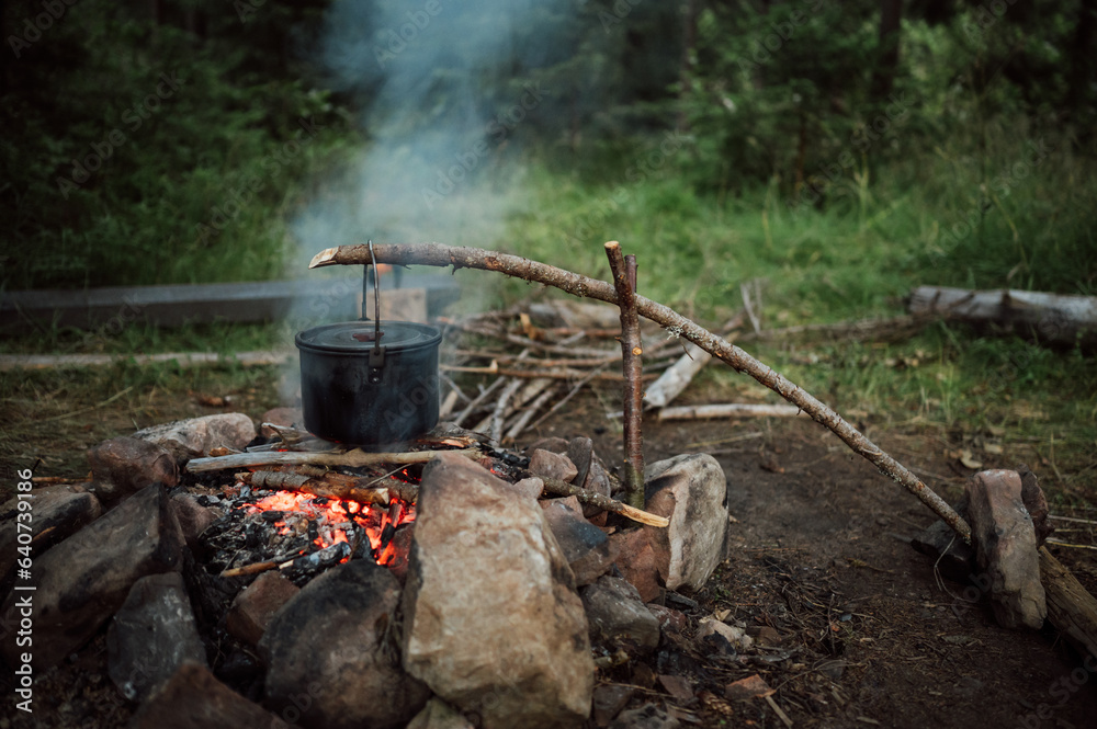 Сooking on fire in a tourist cauldron on a camping trip Сooking on fire in a tourist cauldron on a camping trip