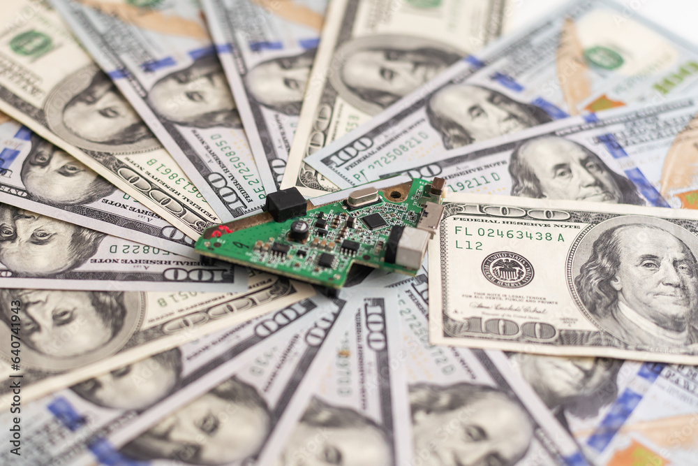 Electronic circuits, microchips, substrates for technology with dollars lying nearby. Electronics cost concept Electronic circuits, microchips, substrates for technology with dollars lying nearby. Electronics cost concept