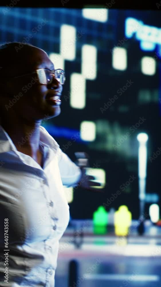 Vertical video Cheerful businesswoman bopping around and greeting other pedestrians, walking on city streets at night. Lively woman enjoying herself while strolling on metropolitan avenues Vertical video Cheerful businesswoman bopping around and greeting other pedestrians, walking on city streets at night. Lively woman enjoying herself while strolling on metropolitan avenues