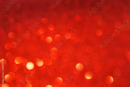Red de focused sparkle glitter background with golden particles close up 