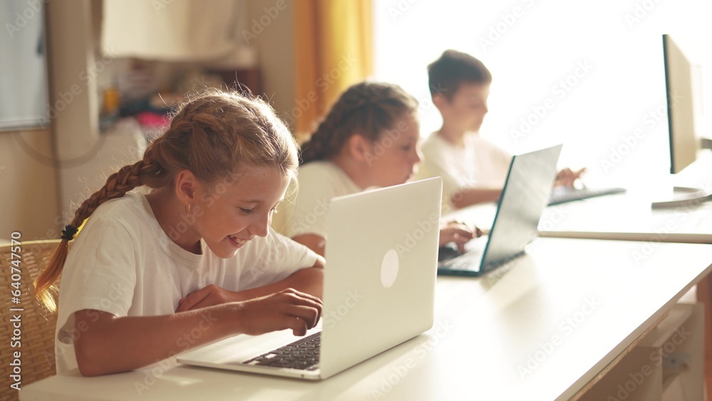 children learn from home through computers. business concept of modern training and development. a group of little kids perform tasks in a lifestyle laptop at home schooling. educating from home children learn from home through computers. business concept of modern training and development. a group of little kids perform tasks in a lifestyle laptop at home schooling. educating from home